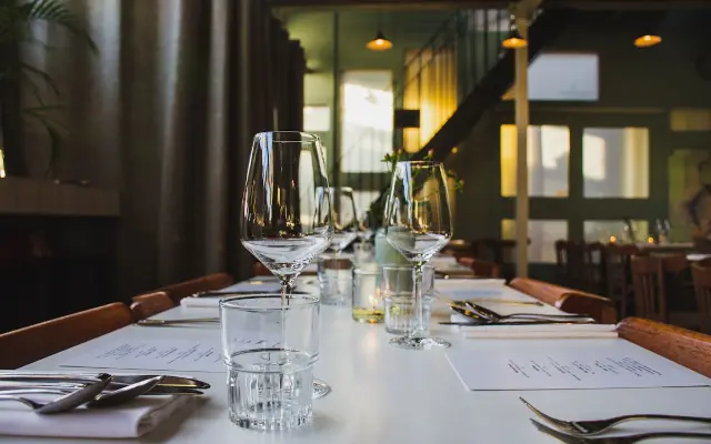 A dining table set with glassware in a restaurant.