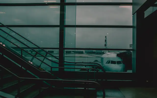 An aircraft seen through an airport window.