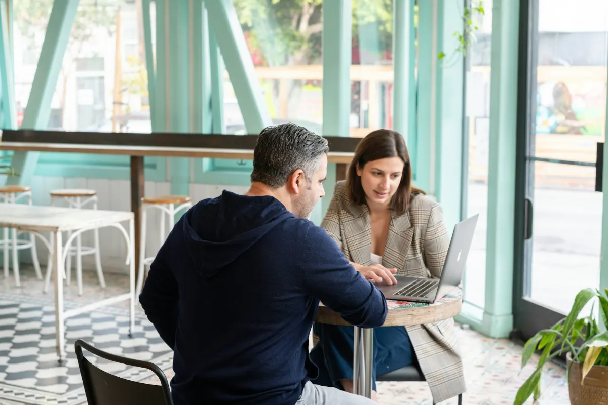 A DealZ team member and a business owner going through the partnership together over a laptop.