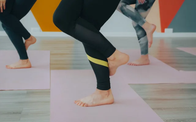 A group taking part in a yoga class at a studio