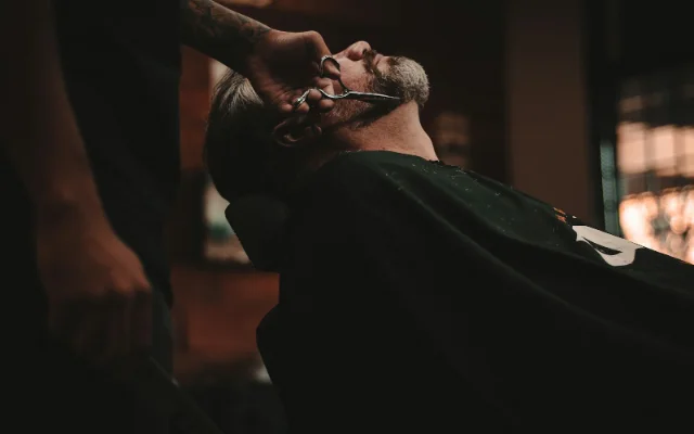 A customer having a haircut at a local barber shop